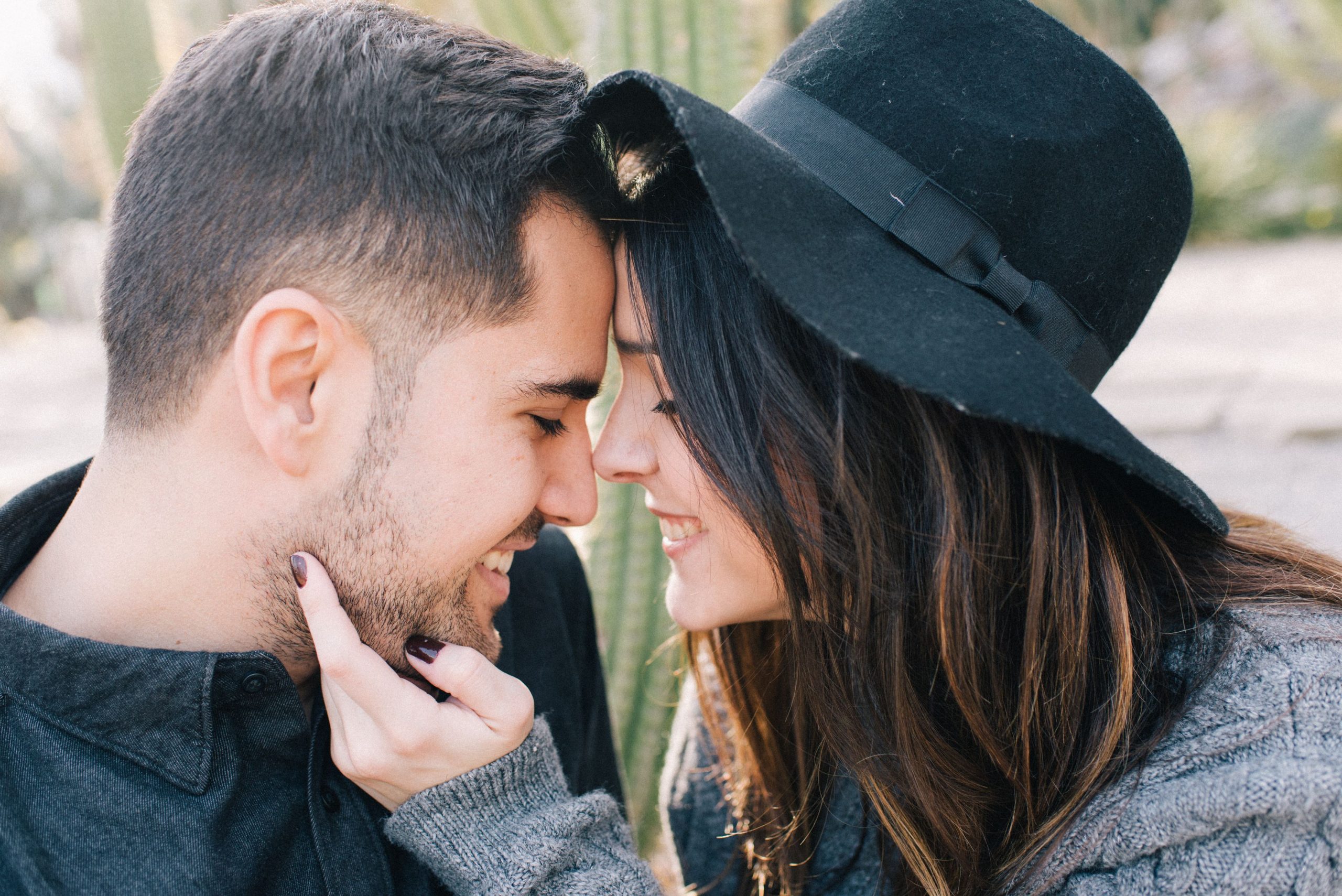 Couple souriant se touchant le visage dehors tendrement